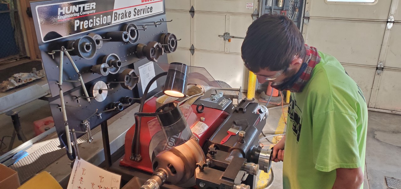 Automotive Student working at a Precision Brake Station